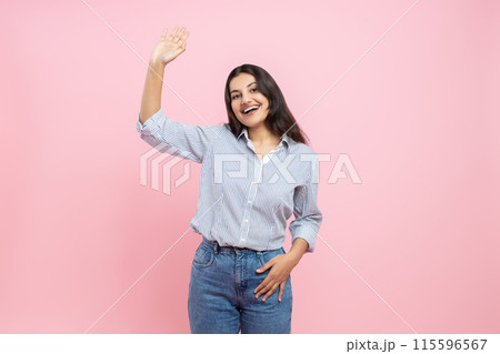 Friendly Indian woman waving hand hello gesture 115596567