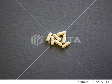 Healthy lifestyle symbol. White vitamins tablets, calcium, Omega Vitamin C. Pills on a white background. Web banner. Beautiful background. Copy space. Medical and healthy lifestyle concept. 115597913