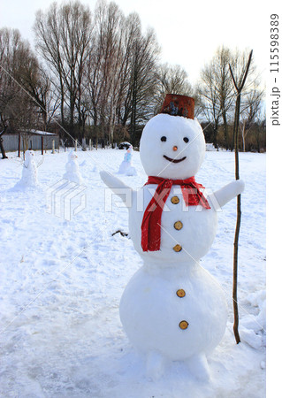 Snowman cheerful. New Year attribute. Christmas snowman made in the garden 115598389