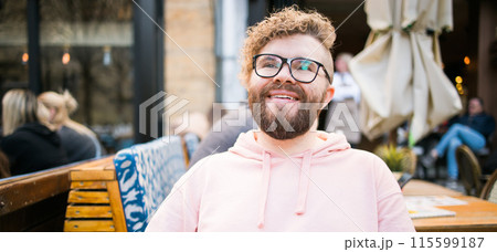 Banner Millennial bearded man having breakfast at table of street cafe on spring day, drinking warm cappuccino. Spring restaurant terrace Banner Millennial bearded man having breakfast at table of street cafe on spring day, drinking warm cappuccino. Spring restaurant terrace 115599187