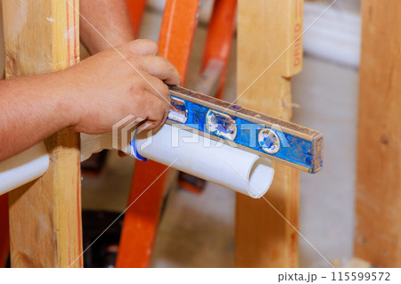 With help of level, sanitary pipes are leveled during gluing With help of level, sanitary pipes are leveled during gluing 115599572