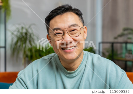 Happy Asian man smiling friendly, glad expression, feel satisfied concept good news celebrate win Happy Asian man smiling friendly, glad expression, feel satisfied concept good news celebrate win 115600583