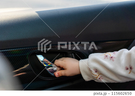 Child opens car door from inside. Concept of danger in car Child opens car door from inside. Concept of danger in car 115602650