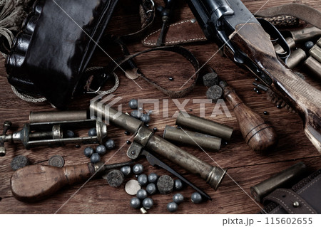 break-action smooth bored shotgun with brass cases and accessories for cartridge reloading. break-action smooth bored shotgun with brass cases and accessories for cartridge reloading. 115602655