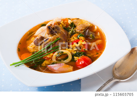 Lamb's soup cooked with rice, vegetables, onion and garlic 115603705