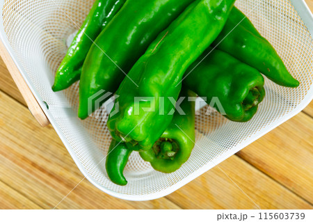 Green peppers on wooden table, cooking ingredients Green peppers on wooden table, cooking ingredients 115603739