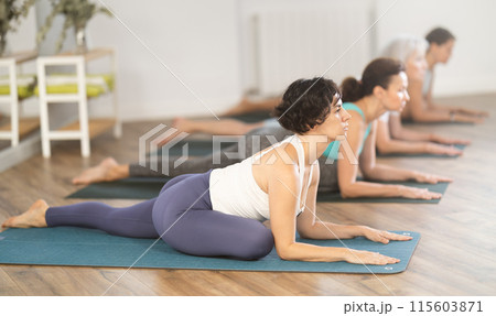 Woman stretching in seated asana Ardha Kapotasana at yoga class 115603871