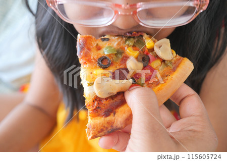 Child Enjoying a Slice of Veggie Pizza Up Close, Pizza Topping Close-up, Pizza Tasting Moment  Child Enjoying a Slice of Veggie Pizza Up Close, Pizza Topping Close-up, Pizza Tasting Moment  115605724