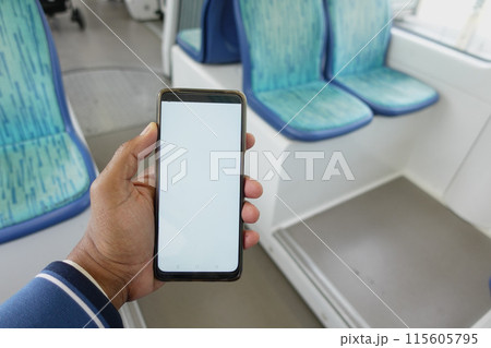young man hand using smart phone with white screen inside of metro train 115605795