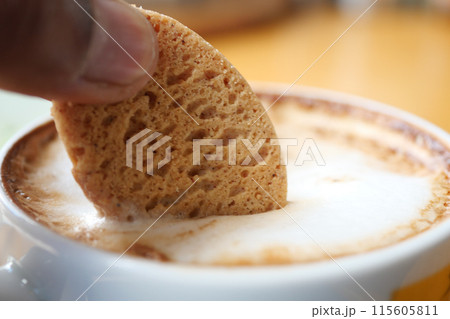 pouring sweet cookies in a coffee mug on wooden table  115605811