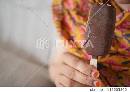 young women eating chocolate flavor ice cream  115605866