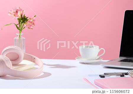Office theme photo in pink color tone from front angle, blank space in the center of white countertop for product displaying, variety office necessities. Copy space for adding text Office theme photo in pink color tone from front angle, blank space in the center of white countertop for product displaying, variety office necessities. Copy space for adding text 115606072