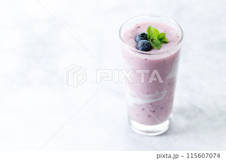 Blueberry smoothie with yogurt in a glass. 115607074