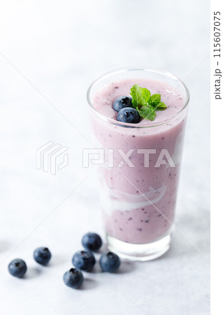 Blueberry smoothie with yogurt in a glass. Blueberry smoothie with yogurt in a glass. 115607075