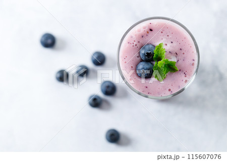 Blueberry smoothie with yogurt in a glass. 115607076
