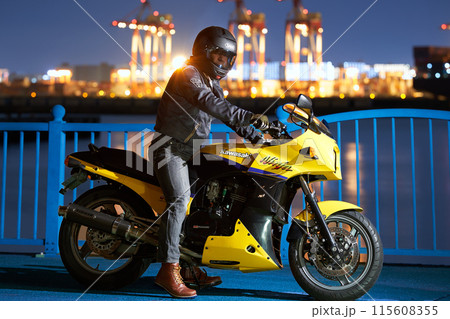 夜の港でバイクにまたがる男性 夜の港でバイクにまたがる男性 115608355