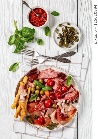 italian antipasto plate of cured meat and veggies 115610994