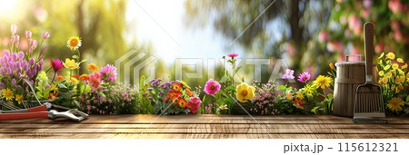 Various colorful flowers and garden tools arranged neatly on a wooden table, against a blurred natural background. Generative AI 115612321
