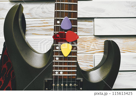 Fretboard of electric guitar with plectrums mediators Fretboard of electric guitar with plectrums mediators 115613425