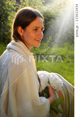 Smiling girl with a bouquet of peonies Smiling girl with a bouquet of peonies 115613434