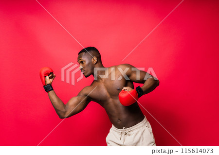 Young attractive African American male boxer with bare torso, muscular body. Concept of training Young attractive African American male boxer with bare torso, muscular body. Concept of training 115614073