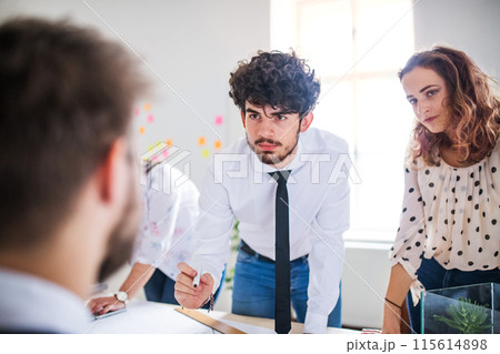 Businessman having quick lunch, fastfood meal in startup company office. Working in co-working space. Businessman having quick lunch, fastfood meal in startup company office. Working in co-working space. 115614898