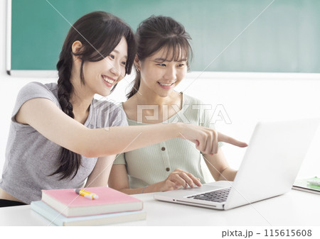 Two students studying together and watching the laptop 115615608