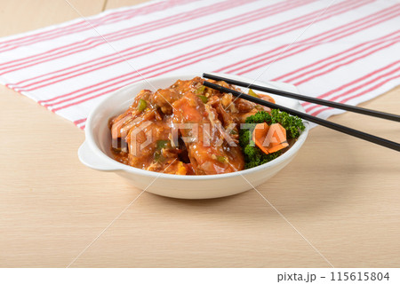 A bowl of Prawn with chopsticks on a table. The food is a mix of meat and vegetables, and the chopsticks are placed on top of the food A bowl of Prawn with chopsticks on a table. The food is a mix of meat and vegetables, and the chopsticks are placed on top of the food 115615804