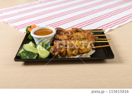 A plate of meat with a sauce and vegetables A plate of meat with a sauce and vegetables 115615816