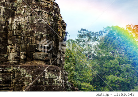The bayon temple smiling stone faces showing on a sunny day in angkor thom, siem reap, cambodia The bayon temple smiling stone faces showing on a sunny day in angkor thom, siem reap, cambodia 115616545