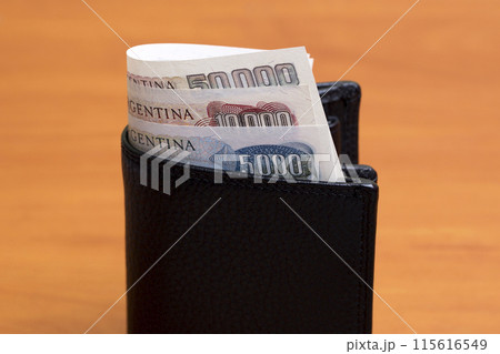 Old Argentine peso in the black wallet Old Argentine peso in the black wallet 115616549