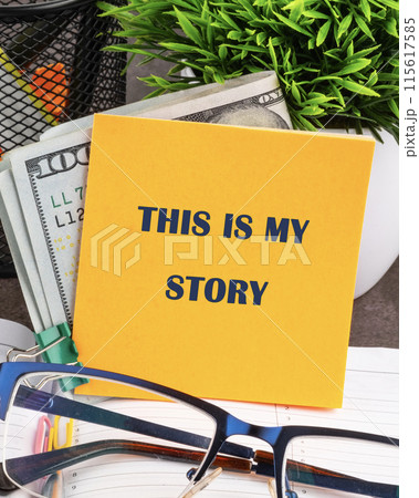 Life and business motivational inspirational concept. Text THIS IS MY STORY on a yellow sticker on the background of money Life and business motivational inspirational concept. Text THIS IS MY STORY on a yellow sticker on the background of money 115617585