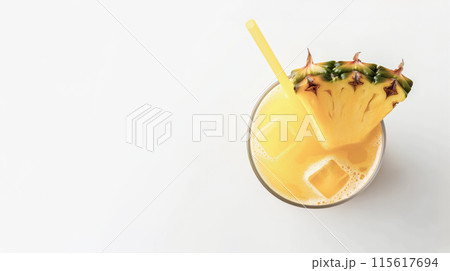 A top view of a pineapple juice garnished with a pineapple slice and straw A top view of a pineapple juice garnished with a pineapple slice and straw 115617694