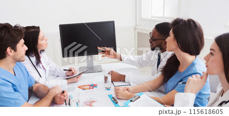 Online medical education. Doctors having lecture and taking notes in meeting room Online medical education. Doctors having lecture and taking notes in meeting room 115618605