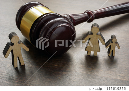 Divorce and alimony concept. Divided family figurines and a gavel. 115619256