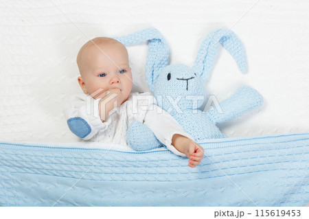 Little baby on white bed Little baby on white bed 115619453