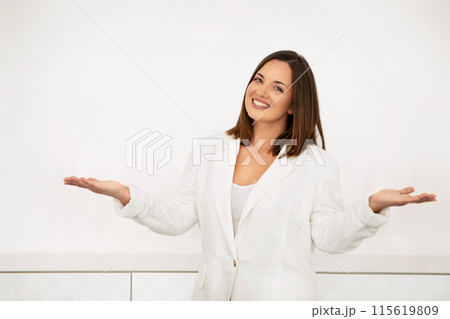 Business Offer And Consultation. Happy Businesswoman Smiling Looking At Camera, Standing Over White Office Wall Indoor, Gesturing And Consulting, Inviting To Use Her Agent Or Advisor Services Business Offer And Consultation. Happy Businesswoman Smiling Looking At Camera, Standing Over White Office Wall Indoor, Gesturing And Consulting, Inviting To Use Her Agent Or Advisor Services 115619809