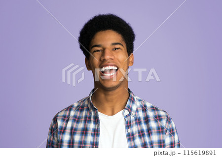 Excited guy laughing and looking at camera over pink background 115619891