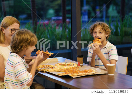Family eating pizza. Italian restaurant. Family eating pizza. Italian restaurant. 115619923