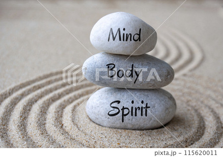 Mind, body and soul text on zen stones with sand background 115620011