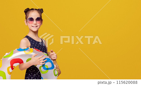 Love swimming fun! Adorable girl with inflatable ring smiling on pink panorama background with empty space Love swimming fun! Adorable girl with inflatable ring smiling on pink panorama background with empty space 115620088