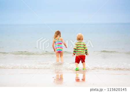 Kids playing on beach. Children play at sea. Kids playing on beach. Children play at sea. 115620145