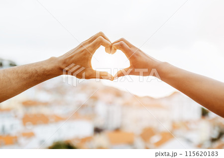 Hands of young african american guy and lady make heart sign, enjoy date, love story and travel, outdoor. Relationships, holiday, vacations and romance, marriage and engagement 115620183
