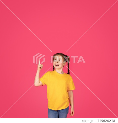 Look There. Excited Female Child Pointing Up With Finger, Showing Copy Space, Preteen Caucasian Girl Showing Free Place Above Her Head For Your Advertisement Or Offer, Standing Over Pink Background 115620218