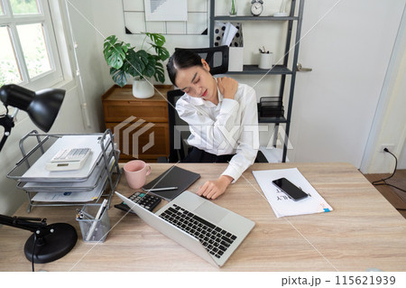 Business Professional Experiencing Neck Pain While Working at Desk in Modern Office Setting Business Professional Experiencing Neck Pain While Working at Desk in Modern Office Setting 115621939