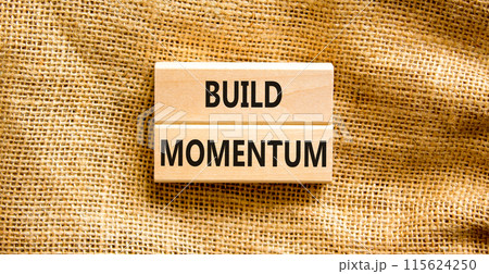 Build momentum symbol. Concept words Build momentum on wooden blocks. Beautiful canvas table canvas background. Business and build momentum concept. Copy space. Build momentum symbol. Concept words Build momentum on wooden blocks. Beautiful canvas table canvas background. Business and build momentum concept. Copy space. 115624250