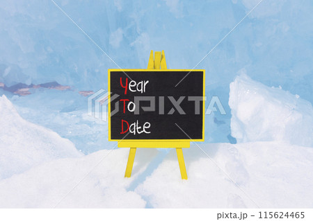 YTD year to date symbol. Concept words YTD year to date on beautiful yellow blackboard. Beautiful blue ice background. Business YTD year to date concept. Copy space. YTD year to date symbol. Concept words YTD year to date on beautiful yellow blackboard. Beautiful blue ice background. Business YTD year to date concept. Copy space. 115624465