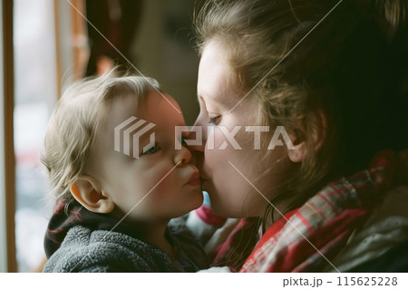 Heartwarming image capturing a gentle kiss from a mother to her young child Heartwarming image capturing a gentle kiss from a mother to her young child 115625228