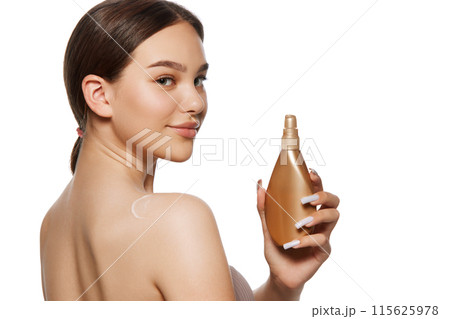 Beautiful young girl taking acre after her body, applying moisturizing cram, body lotion isolated on white background Beautiful young girl taking acre after her body, applying moisturizing cram, body lotion isolated on white background 115625978