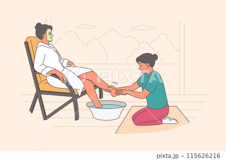 Woman visits SPA salon and enjoys foot massage service, sitting in chair with cosmetic mask on face 115626216